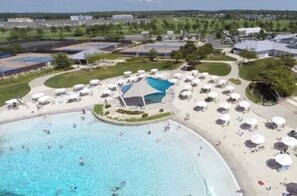 Relax by the spacious pool surrounded by lush greenery and scenic views.