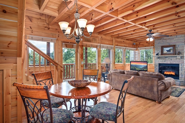 Dining table and open concept living room with panoramic windows