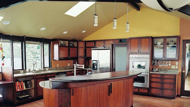 A kitchen with wooden cabinets, a central island, stainless steel appliances, and pendant lighting. - Immaculate, warm, inviting with WOW water views! You'll wish you lived here! (Port Angeles)