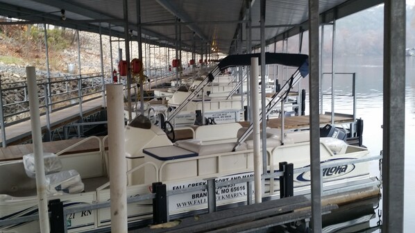 Boats are docked in this covered storage area, each with its own nameplate and amenities.
