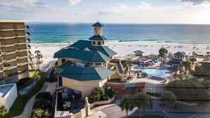A resort with a pool, beach, and ocean view.