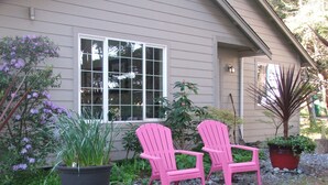 A house with a large window, two pink Adirondack chairs, and various potted plants. - Rare Strait of Juan de Fuca no-bank water front, near mouth of Elwha River. (port angeles)