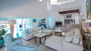 A spacious living area with a sofa set, a coffee table, and a dining area with chairs and a table. - FantaSea beachfront, every bedroom facing ocean! Remodeled 2024 (Upper Prince's Quarter)