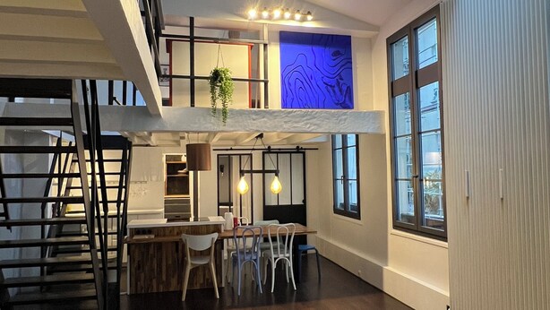 A spacious loft-style living area with a high ceiling, skylight, and a dining area with modern furniture. - TOP LOCATION, TOP CENTER , POMPIDOU/MARAIS/LOUVRE (Paris)