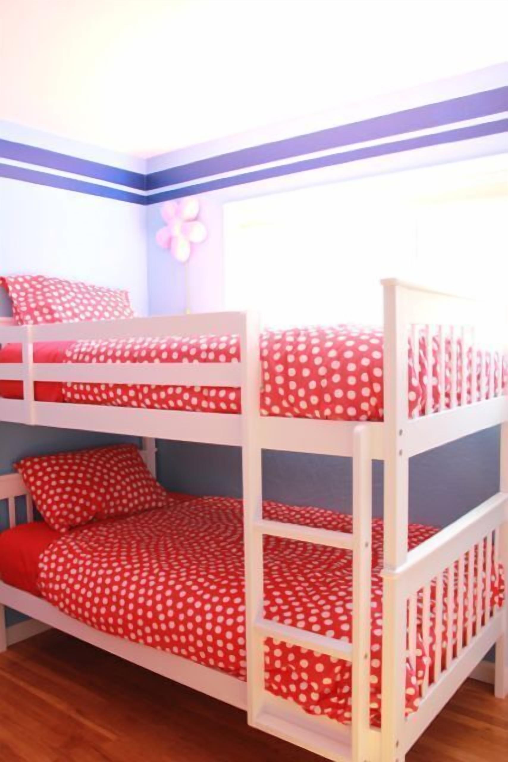 A bunk bed with red polka dot bedding.