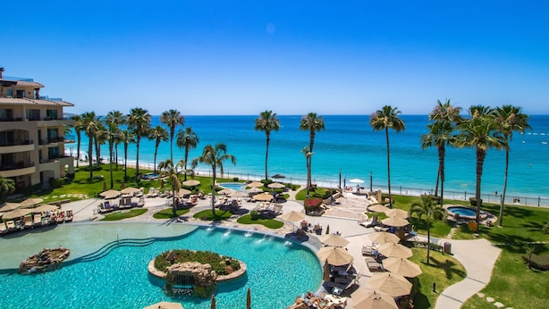 A resort with a large pool, palm trees, and a view of the ocean. - Villa La Estancia Resort-Medano Beach GORGEOUS, LUXURY 2 bd+3 bath private villa (Cabo San Lucas)