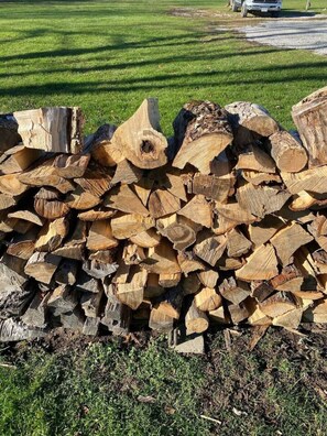 A stack of cut logs. - Strip Location | Pet Friendly | Fire Pit (Geneva)