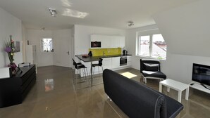 A modern apartment with a living room, kitchen, and dining area. - Modern, Architect-Designed Penthouse Loft With 2 Outdoor Roof Terraces (Vienna)