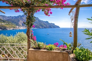 Enjoy breathtaking views of the sea and surrounding mountains from this balcony.