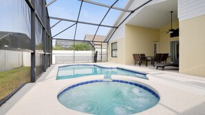 A pool area with a hot tub and lounge chairs. - The World Villa , South-Facing Pool & Spa , Free Wi-Fi , 3 Miles to Disney (KISSIMMEE)