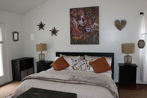 A bedroom with a bed, two nightstands, a dresser, and a painting on the wall. - Red Rock Retreat: Hot tub, walk to creek for swimming,. (Sedona)