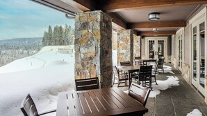 A covered outdoor area with stone pillars, wooden beams, and a view of a snowy landscape. - 4070 Wilderness Retreat with Modern Amenities! (Cle Elum)