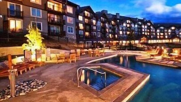 A hotel with a swimming pool, outdoor seating, and multiple buildings with balconies. - 4070 Wilderness Retreat with Modern Amenities! (Cle Elum)