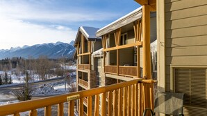A hotel with a balcony overlooking a snowy mountain landscape.