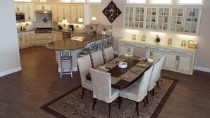 A modern kitchen with a central island, dining area with chairs, and built-in cabinets. - Incredible Ocean Views 3 Bedrooms 3 Bathrooms (Trinidad)