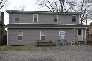 A two-story building with a sign reading 'Edgewater Lodge.' There is a bench outside and a small staircase leading to the entrance. - Lake Access Retreat Pet Friendly Fire Pit (Geneva)