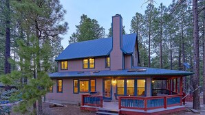 A cabin with a porch, a chimney, and a deck. - Woodsy family getaway: private, hiking, wood stove, sleeps 12 (Parks)