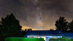 A house with a starry night sky, surrounded by greenery. - Stunning Views, close to Wineries, Primland & Parkway - beautifully appointed (Meadows of Dan)