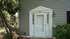 A house with a white front door, number 225, and a small porch with steps leading up to it. - Beautiful Townhome 10 min from Charleston & Beaches, Pool, Tennis Court! (Charleston)