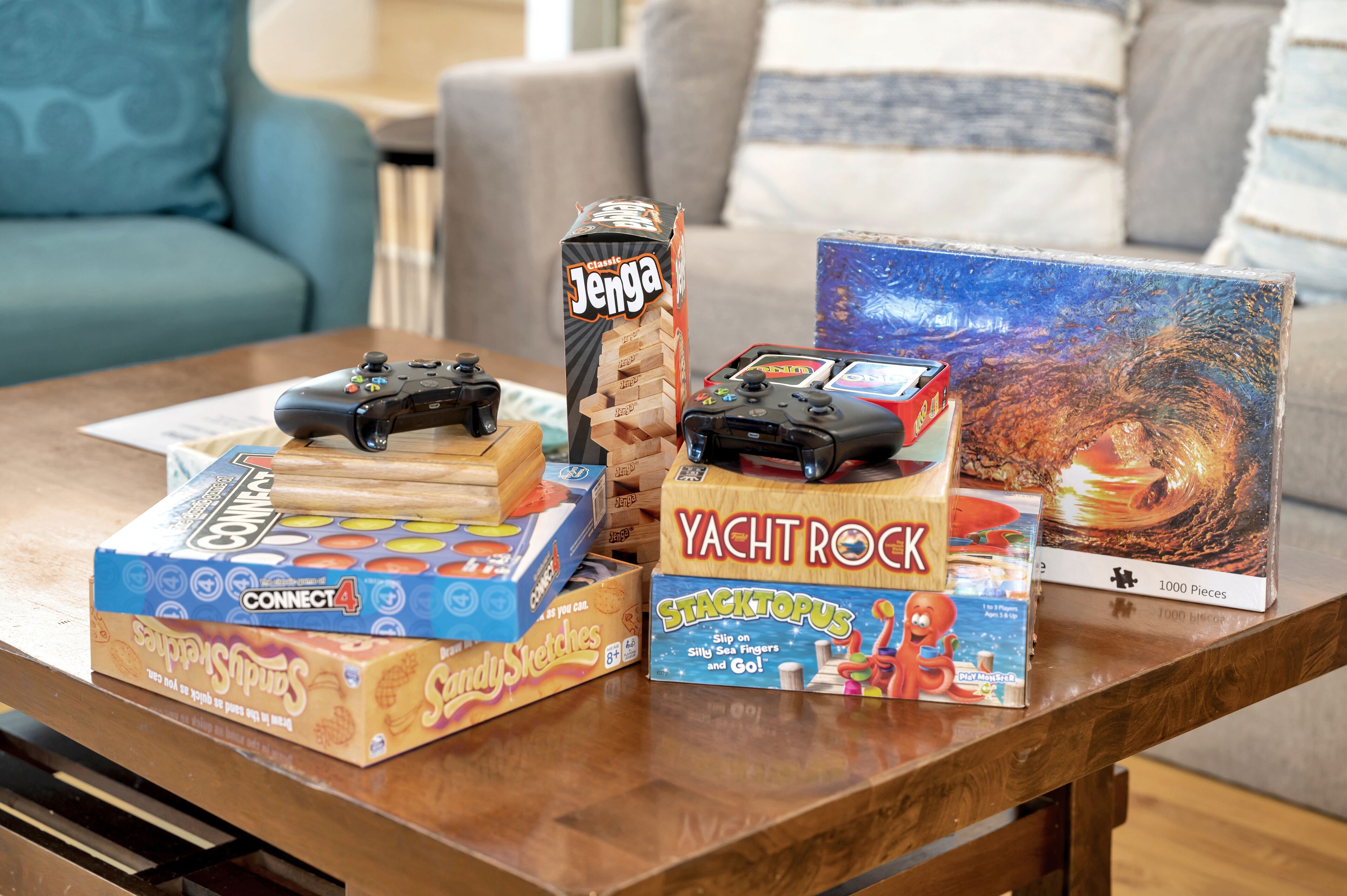 A table with various board games and gaming controllers.