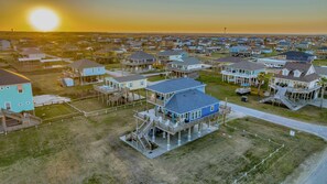 A coastal residential area with houses featuring multiple decks and balconies, some with attached porches.