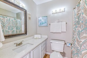 A bathroom with a large mirror, a sink, a toilet, and a shower curtain. - Beach Area Condo, 2bed-2bath, Seabreeze 309 (Gulf Shores)