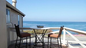 A deck with two chairs and a table, overlooking the ocean. - 180º ocean views in a central location 2bd+den, 2baths (Pacific Grove)