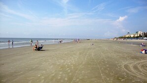A wide sandy beach with footprints and a few people. - Inviting Palmetto Dunes condo w/ pool, private W/D & deck near beach & golf (Hilton Head Island)