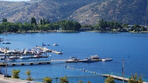 A marina with boats docked, surrounded by hills and trees.