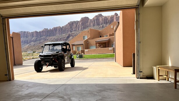 A vehicle parked in a garage with a mountain view. - 8A6 Amazing Views, Shared Pool/Hot Tub, Private Patio and Garage (MOAB)