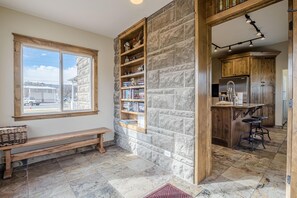 Eine Küche mit Steinwänden, Holzböden und einer integrierten Bar.