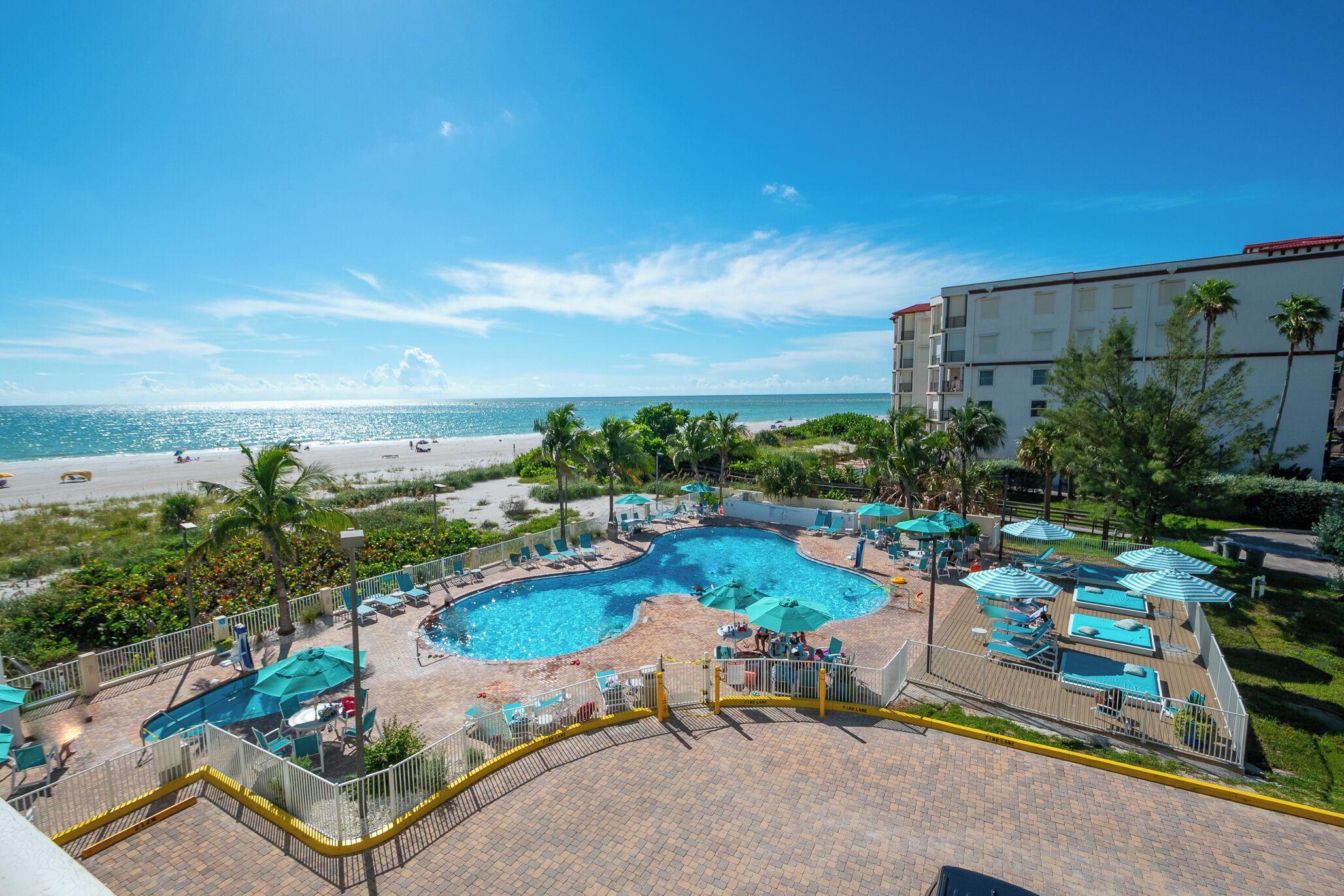 Ein Poolbereich mit Blick auf Strand und Meer.