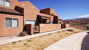 A modern building with a flat roof, numbered 6A4, and a clear blue sky in the background. - 6A4 Views from Patio, Two Car Garage, Community Pool & Hot Tub (Moab)