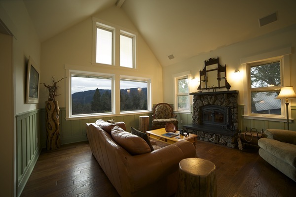 Living room with wood burning fireplace, views of meadow and mountains