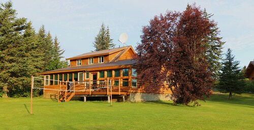 Unique Alaskan log home in trees & wild flowers on 14-acre private homestead.