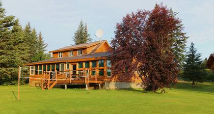Unique Alaskan log home in trees & wild flowers on 14-acre private homestead.