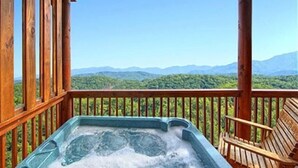 A hot tub on a wooden deck with a mountain view. - 5 miles to Gatlinburg, Hot Tub, Views, 4 BEDROMS: JEEP INVASION, ROD RUN, SPARKS (Pigeon Forge)
