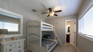 A bedroom with a bunk bed, a dresser, a ceiling fan, and a window with blinds. - Beach block Beauty, 500FT to the beach with chip and putt, Clean and quite.   (Pompano Beach)