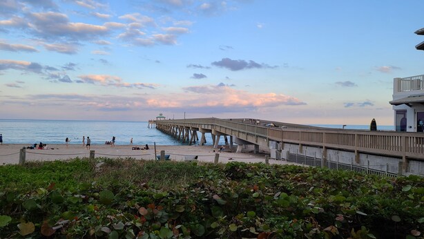 A pier extending into the water with a beach area in the foreground. - Beach block Beauty, 500FT to the beach with chip and putt, Clean and quite.   (Pompano Beach)