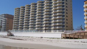 Un hôtel à plusieurs étages doté de balcons, situé près d’une plage.