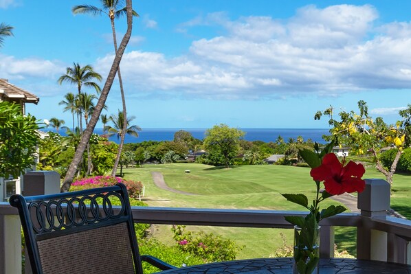 A view from a balcony with a golf course, palm trees, and a clear sky. - 5 Star Ocean View, Beach House Chic, Click the Video tour below! (Wailea)