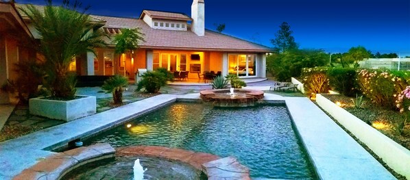 Escape to a serene oasis with a beautifully maintained garden and a tranquil water feature.