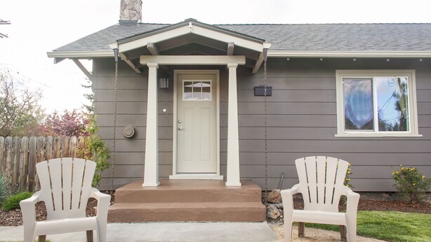 A house with a front porch, two Adirondack chairs, and a small garden. - *NEW* Downtown Modern Nostalgia, completely updated and convenient (Bend)