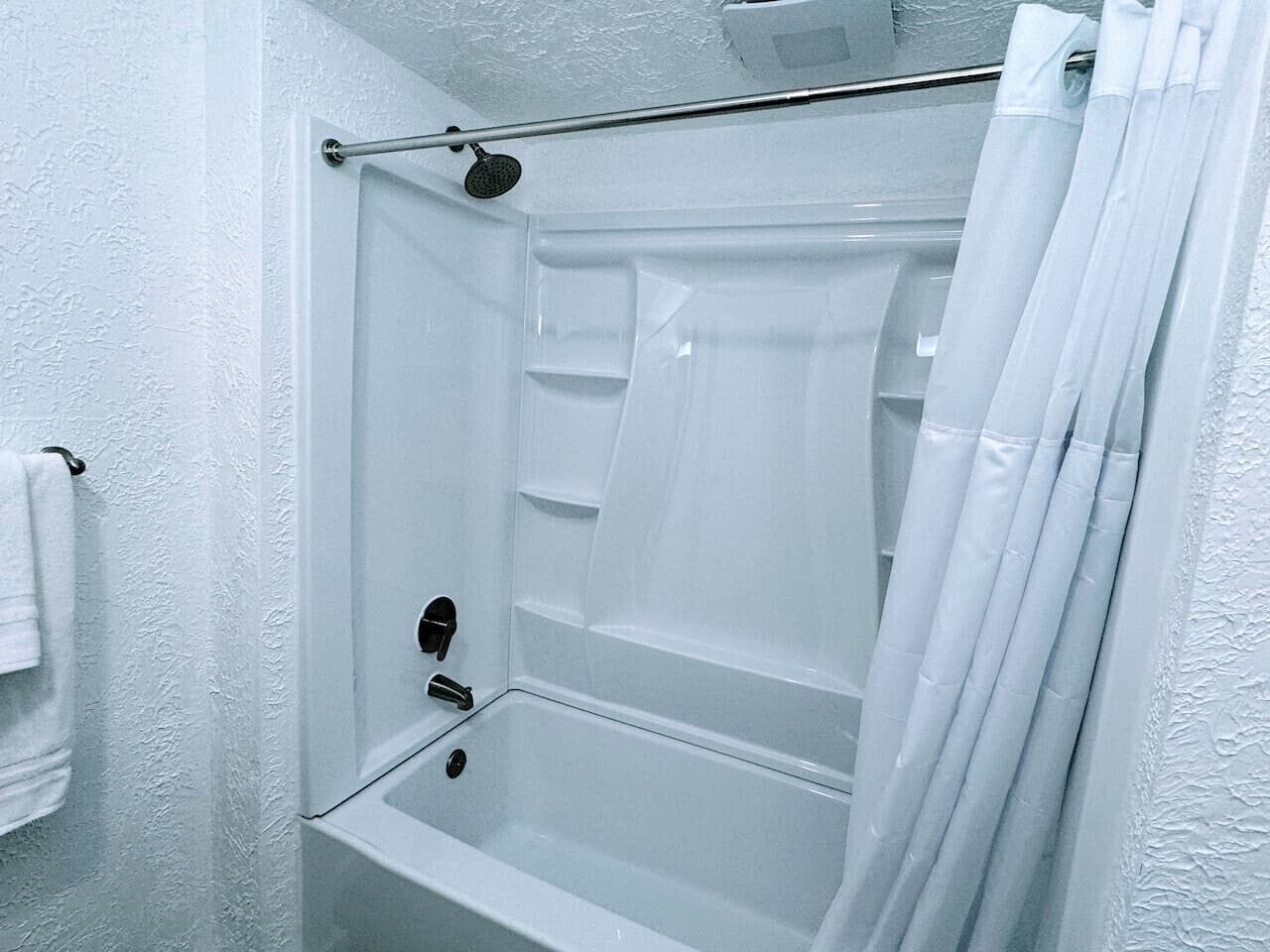 Shower, rainfall showerhead, hair dryer, towels