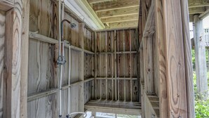 A wooden cabin with a built-in bench and a small window. - "Comes A Time" Oceanfront - Best Surf City location, walk to everything! (Surf City)