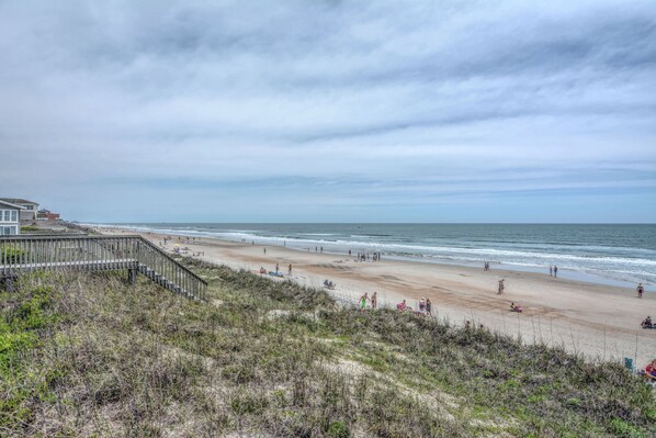 A beach with a wooden boardwalk leading to the shore, sandy beach, and ocean. - "Comes A Time" Oceanfront - Best Surf City location, walk to everything! (Surf City)