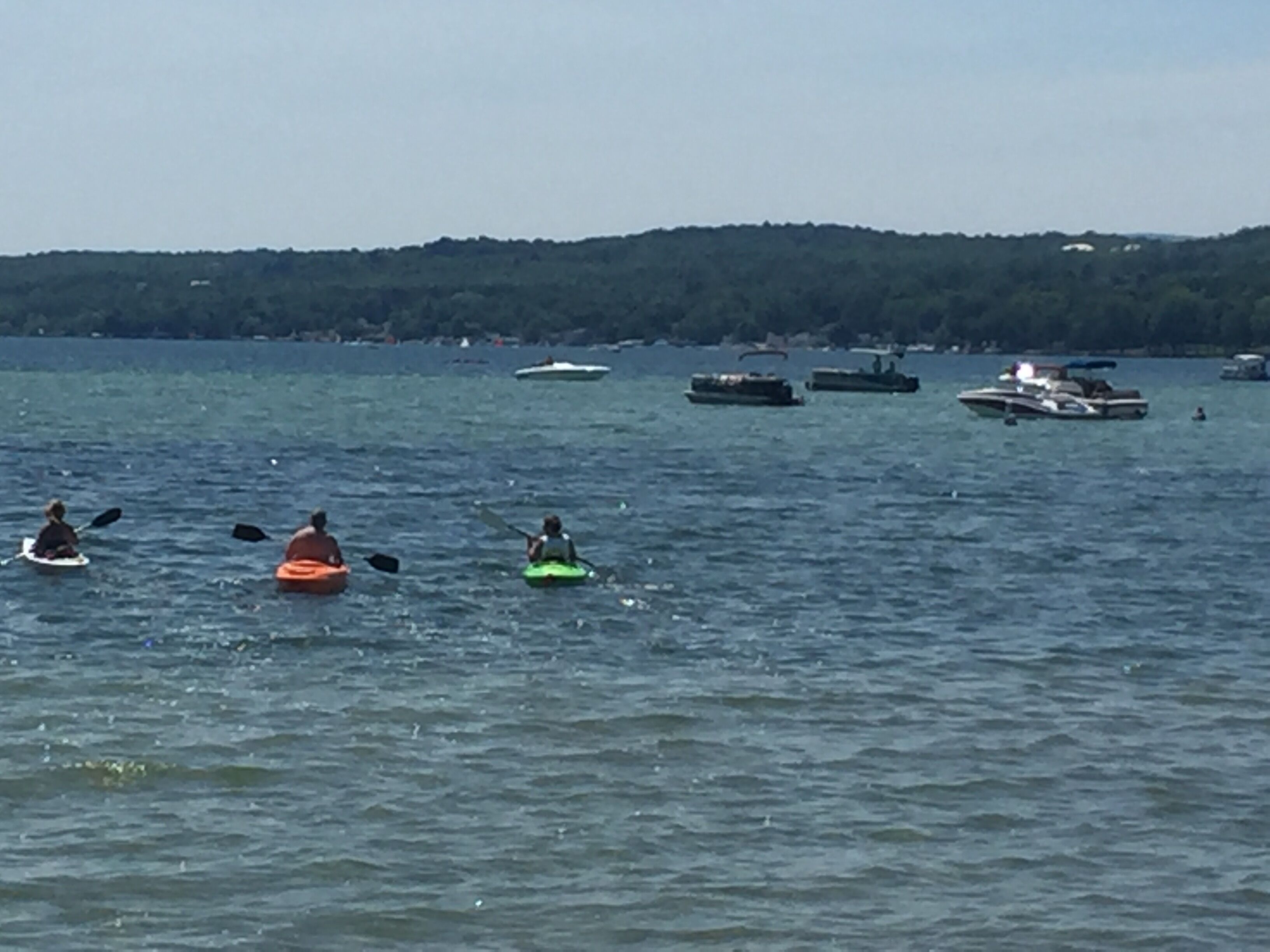 A lake with kayaks and boats.