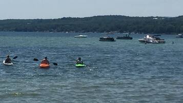 A lake with kayaks and boats.