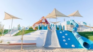 A playground with slides and climbing structures.