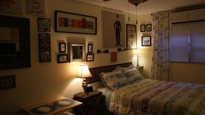 A bedroom with a bed, a nightstand, a lamp, and various wall decorations including framed pictures and a poster. - Studio, Steps to Beach/Broadwalk Pool and Free Parking. Beach Terrace Building (Hollywood)